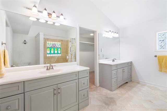 20 Thrasher St, New Orleans, LA 70124 - full bath featuring a sink, two vanities, vaulted ceiling, and a wealth of natural light