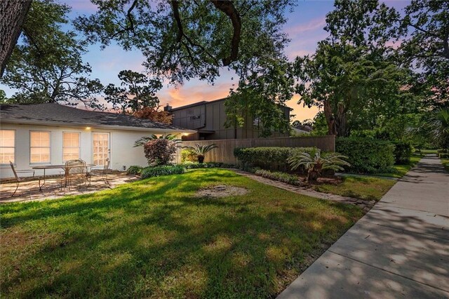 20 Thrasher St, New Orleans, LA 70124 - yard at dusk with fence and a patio