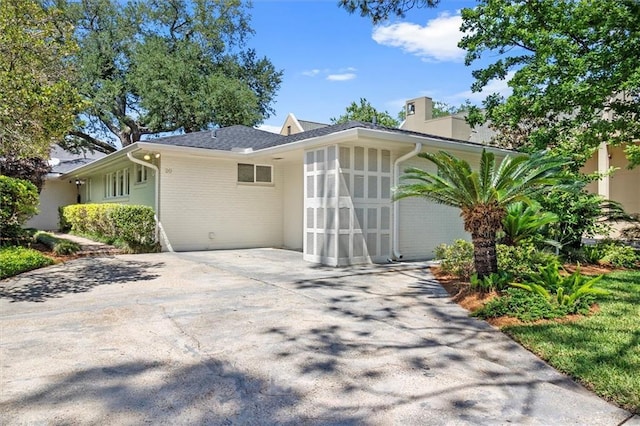 20 Thrasher St, New Orleans, LA 70124 - view of front of home with brick siding, driveway, and a chimney