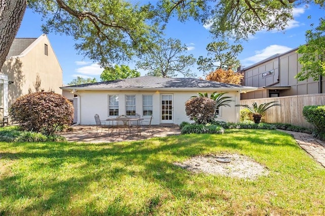 20 Thrasher St, New Orleans, LA 70124 - rear view of house featuring a lawn, brick siding, fence, and a patio area