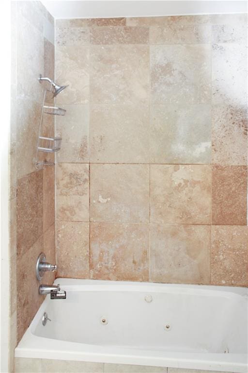 bathroom with a combined bath / shower with jetted tub