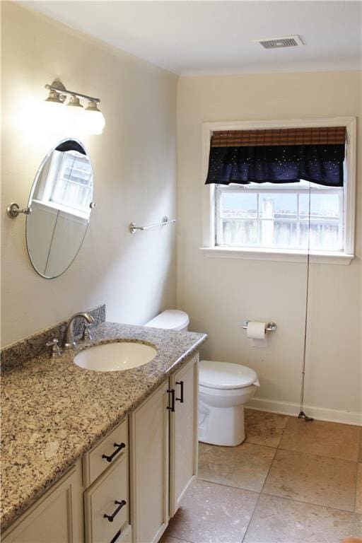 bathroom featuring visible vents, tile patterned flooring, vanity, baseboards, and toilet