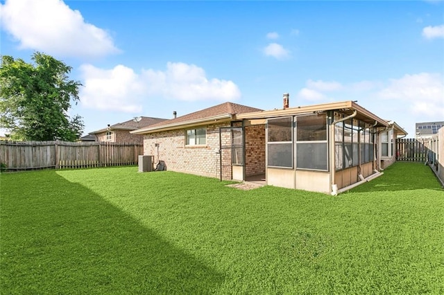 7160 E Renaissance Ct, New Orleans, LA 70128 - back of house featuring a sunroom, a fenced backyard, a lawn, and central air condition unit