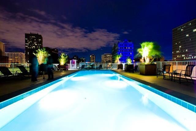 1201 Canal St Unit 416, New Orleans, LA 70112 - pool at twilight with a view of city lights and a community pool