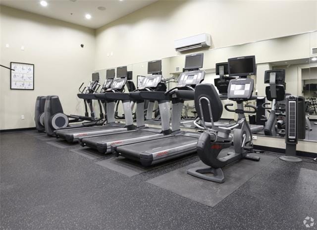 1201 Canal St Unit 416, New Orleans, LA 70112 - exercise room featuring an AC wall unit and recessed lighting
