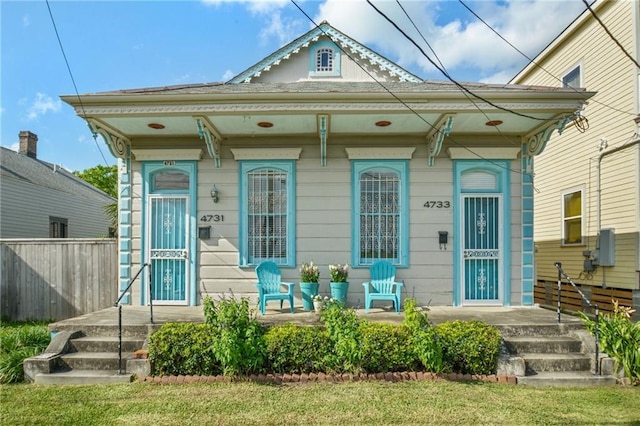 view of front of house featuring a porch and fence