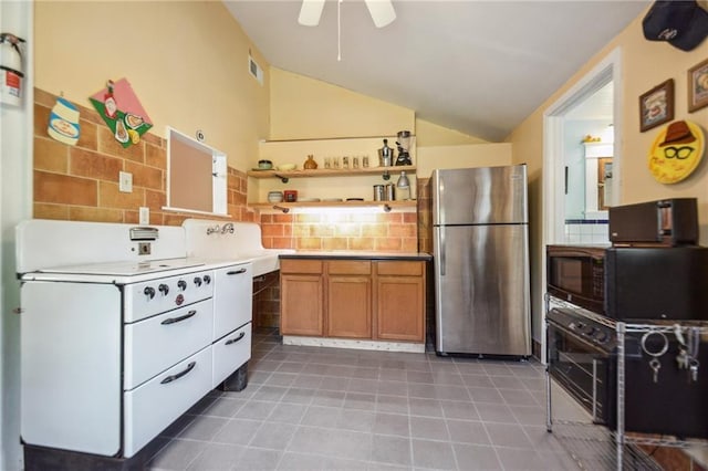 kitchen with a ceiling fan, visible vents, open shelves, vaulted ceiling, and freestanding refrigerator