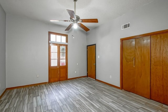 2441 Chartres St, New Orleans, LA 70117 - unfurnished bedroom featuring visible vents, baseboards, ceiling fan, and wood finish floors