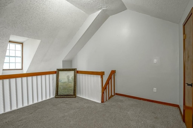 2441 Chartres St, New Orleans, LA 70117 - bonus room with baseboards, carpet, a textured ceiling, and vaulted ceiling