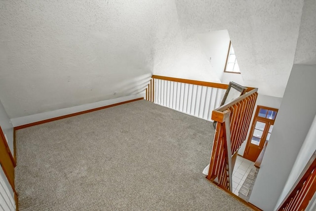 2441 Chartres St, New Orleans, LA 70117 - staircase featuring plenty of natural light, carpet, and a textured ceiling