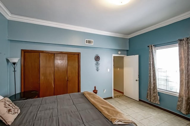 2441 Chartres St, New Orleans, LA 70117 - bedroom featuring visible vents, crown molding, a closet, light tile patterned flooring, and baseboards