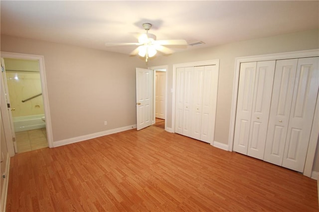 3513 Lemon St, Metairie, LA 70006 - unfurnished bedroom with two closets, light wood finished floors, connected bathroom, and ceiling fan
