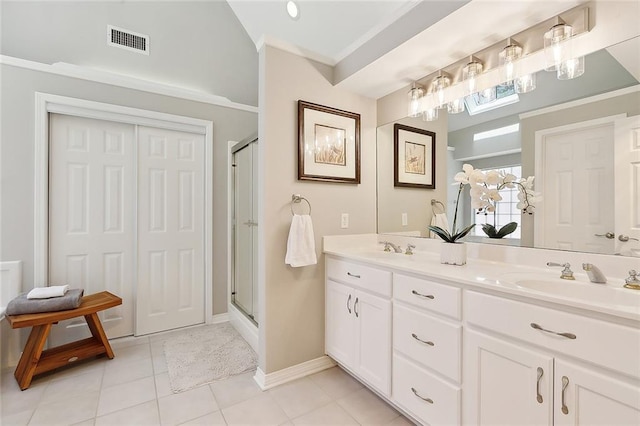 full bath featuring double vanity, a shower stall, tile patterned floors, and baseboards