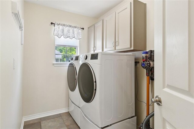 washroom featuring cabinet space, independent washer and dryer, and baseboards