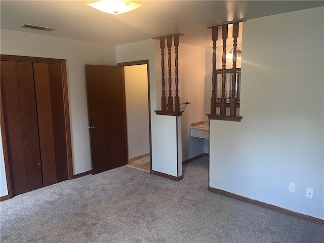 unfurnished bedroom featuring carpet and baseboards