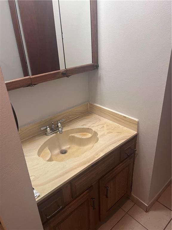 bathroom featuring tile patterned flooring and vanity
