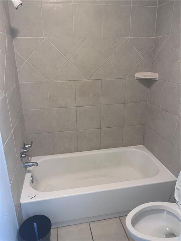 bathroom featuring tile patterned floors, toilet, and  shower combination