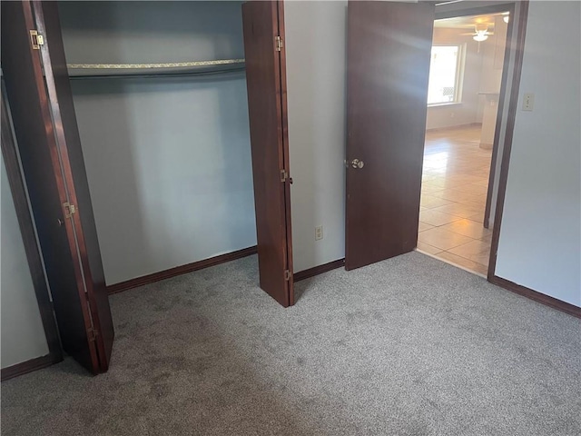 unfurnished bedroom with carpet floors and baseboards
