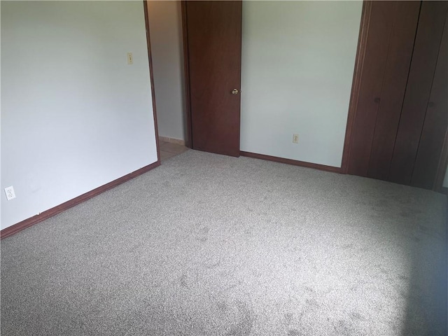 unfurnished bedroom with carpet floors and baseboards