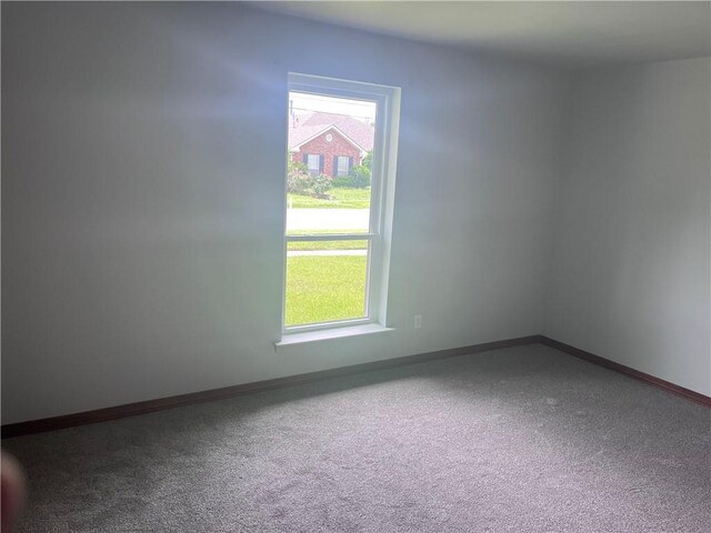 empty room with carpet and baseboards