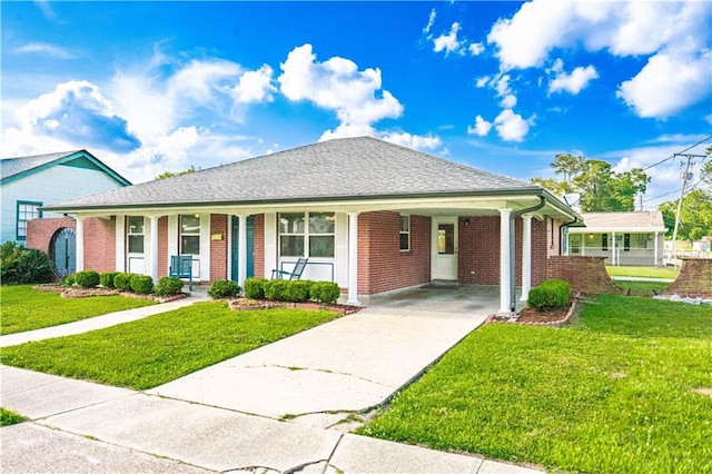 ranch-style house featuring a front lawn, brick siding, an attached carport, concrete driveway, and covered porch