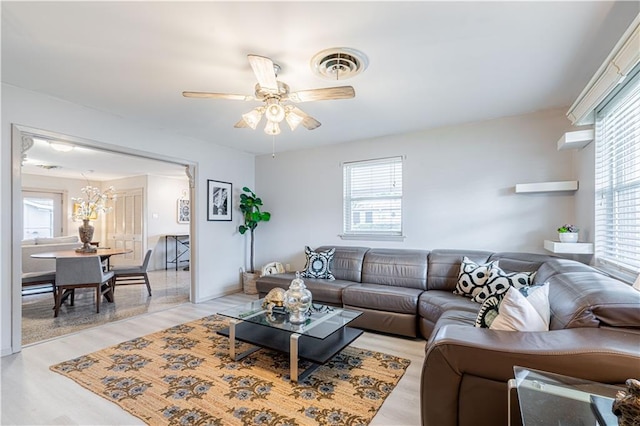 living area featuring ceiling fan, visible vents, and light wood-style floors