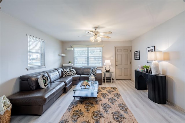 living room with light wood-style flooring and ceiling fan