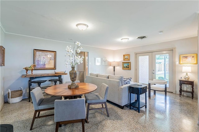dining room with light speckled floor, ornamental molding, french doors, and visible vents