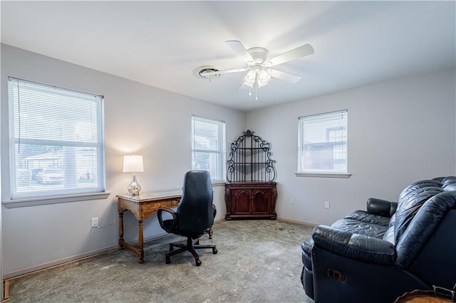 office featuring a ceiling fan, baseboards, and light colored carpet