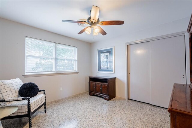 919.5 Perry St, Gretna, LA 70053 - sitting room with dark aggregate flooring, a ceiling fan, and baseboards