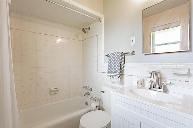 full bathroom featuring vanity, shower / bath combo, toilet, and tile walls