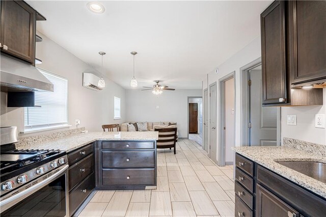 919.5 Perry St, Gretna, LA 70053 - kitchen with stainless steel range with gas stovetop, dark brown cabinets, ceiling fan, and open floor plan