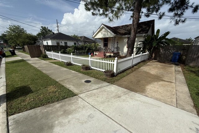 5167 Lafaye St, New Orleans, LA 70122 - view of front of home with a fenced front yard and concrete driveway