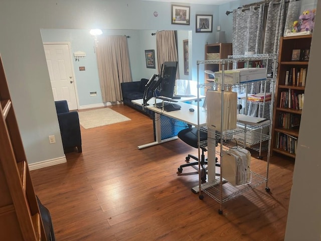 office area featuring baseboards and wood finished floors