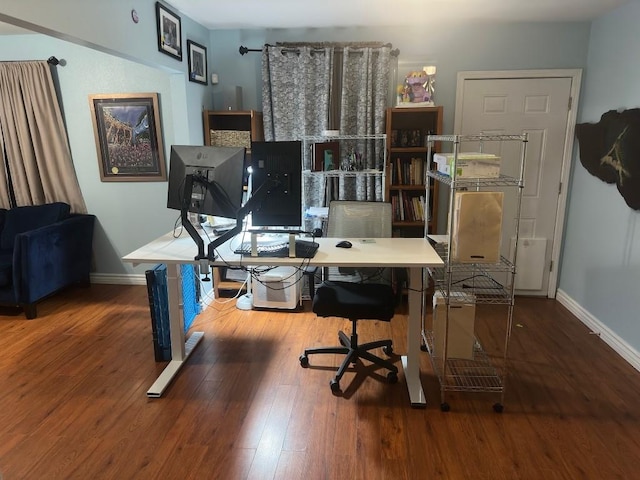 office space featuring baseboards and wood finished floors