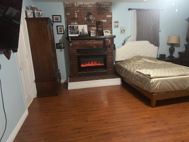 5167 Lafaye St, New Orleans, LA 70122 - bedroom featuring wood finished floors and a brick fireplace
