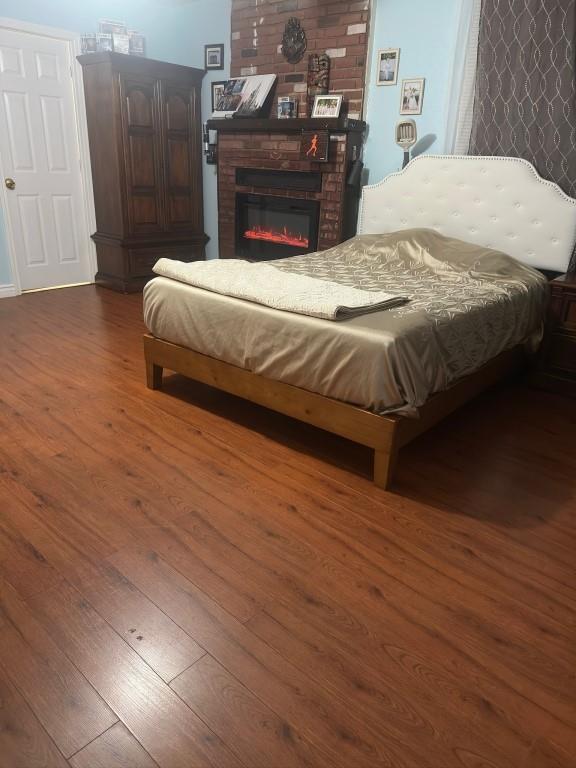 5167 Lafaye St, New Orleans, LA 70122 - bedroom with wood finished floors and a fireplace