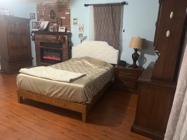 5167 Lafaye St, New Orleans, LA 70122 - bedroom with wood finished floors and a brick fireplace