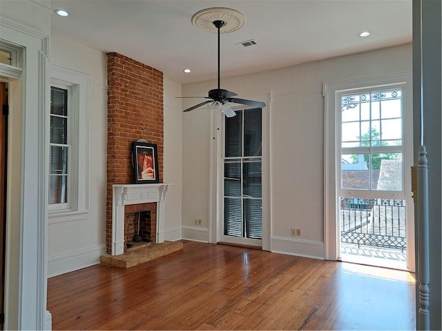 1131 Burgundy St Unit B, New Orleans, LA 70116 - unfurnished living room with recessed lighting, a brick fireplace, wood finished floors, and ceiling fan