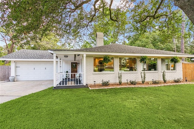 single story home with brick siding, an attached garage, a chimney, and a front yard