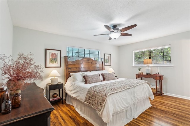 bedroom with baseboards, a ceiling fan, and dark wood-style flooring