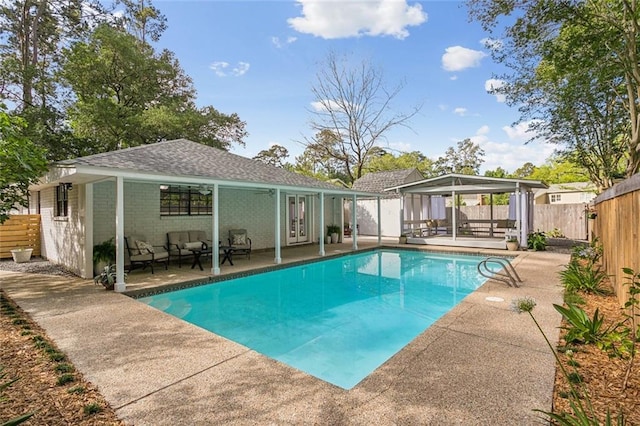 view of pool featuring a fenced backyard, an outdoor hangout area, a fenced in pool, a patio area, and a gazebo