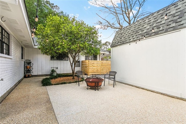view of patio / terrace with fence and an outdoor fire pit