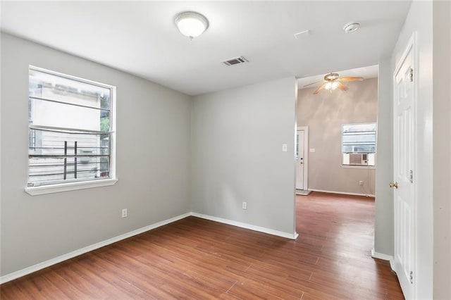 1772 N Dorgenois St, New Orleans, LA 70119 - empty room featuring ceiling fan, cooling unit, baseboards, wood finished floors, and visible vents