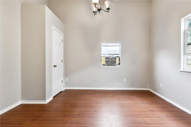 1772 N Dorgenois St, New Orleans, LA 70119 - unfurnished room featuring baseboards, plenty of natural light, wood finished floors, and a chandelier