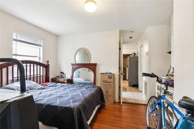 1772 N Dorgenois St, New Orleans, LA 70119 - bedroom featuring freestanding refrigerator and wood finished floors