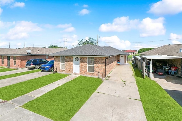 bungalow-style home featuring roof with shingles, concrete driveway, a front yard, and brick siding