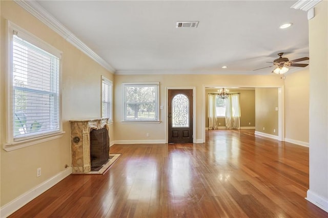 entrance foyer featuring baseboards, visible vents, a healthy amount of sunlight, and wood finished floors