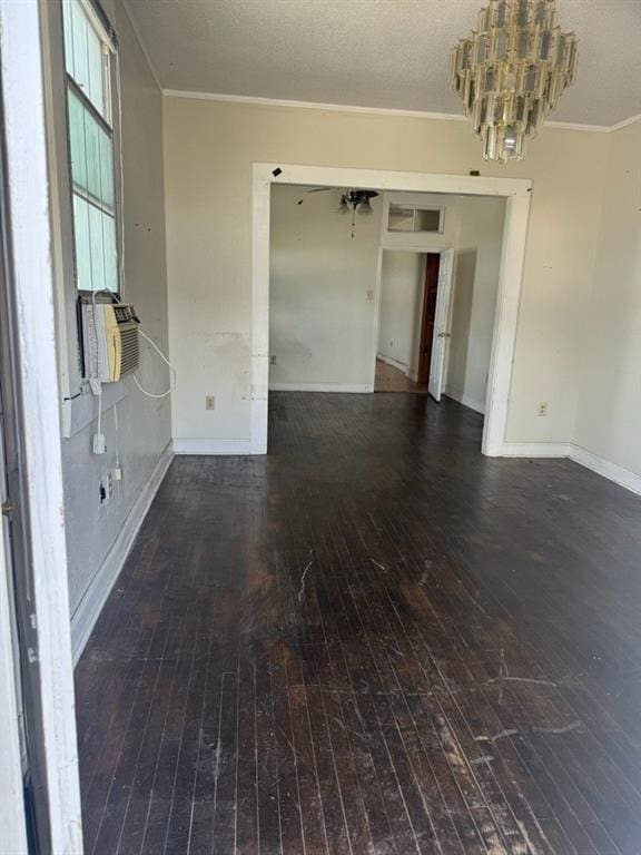 spare room featuring an inviting chandelier, crown molding, cooling unit, and hardwood / wood-style floors