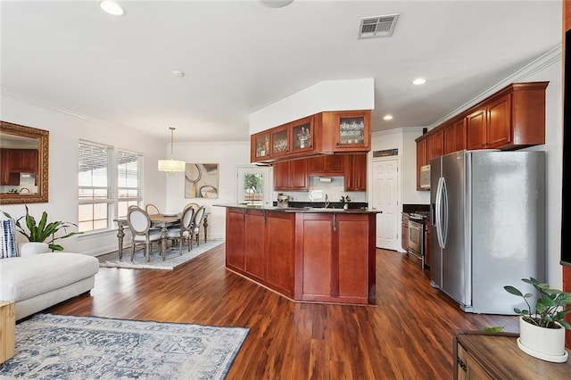 kitchen featuring crown molding, visible vents, dark countertops, stainless steel fridge, and range